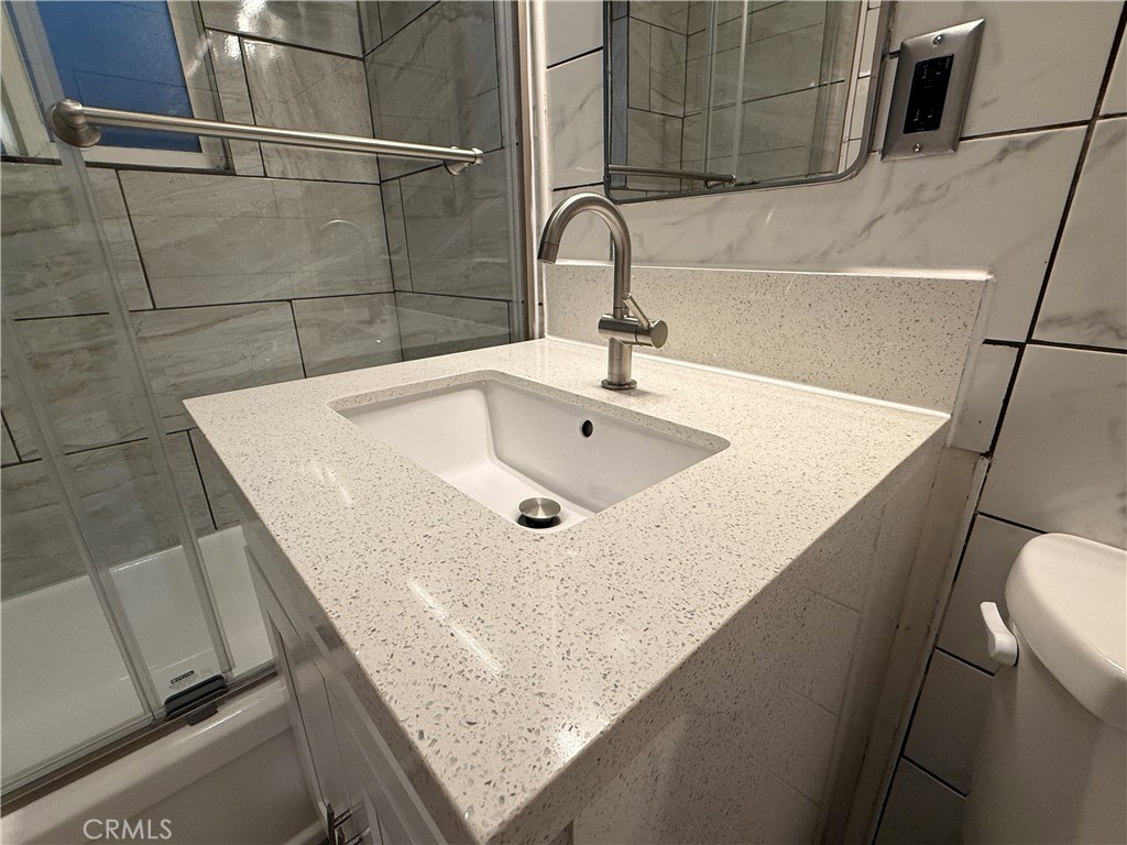 5923 Tyler Street Riverside, CA 92503 - Photo 17 of 19 a bathroom with a sink and a bathtub