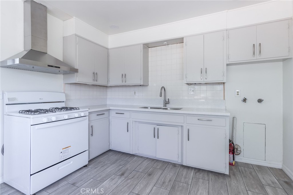 5923 Tyler Street Riverside, CA 92503 - Photo 7 of 19 a kitchen with cabinets appliances a sink and a stove