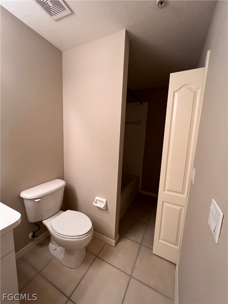 8570 Kingbird Loop, Unit 535 Estero, FL 33967 - Photo 11 of 14 a white toilet sitting next to a bathroom sink