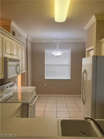 a kitchen with stainless steel appliances kitchen island granite countertop a refrigerator a stove a sink and dishwasher