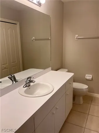 a bathroom with a sink a toilet and mirror
