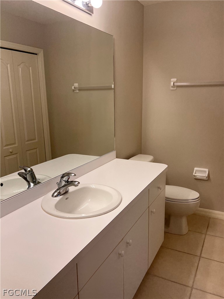8570 Kingbird Loop, Unit 535 Estero, FL 33967 - Photo 8 of 14 a bathroom with a sink a toilet and mirror