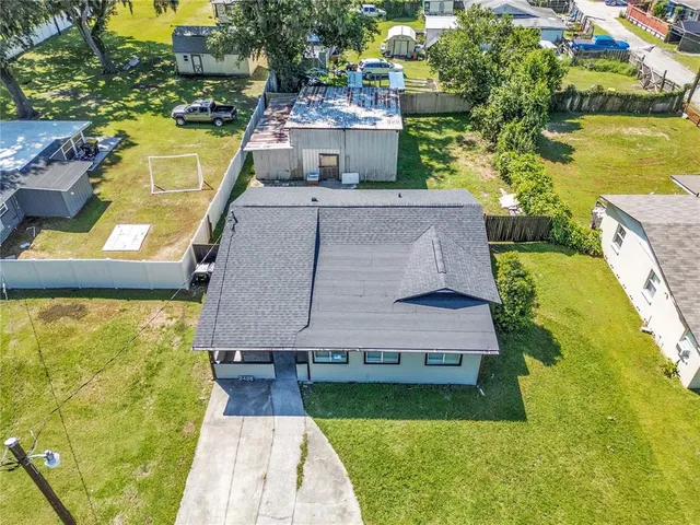 an aerial view of a house with a garden and swimming pool
