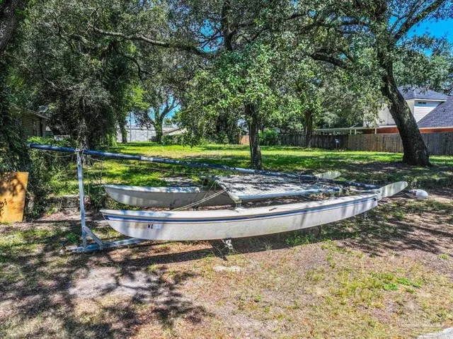 a view of a yard with large trees