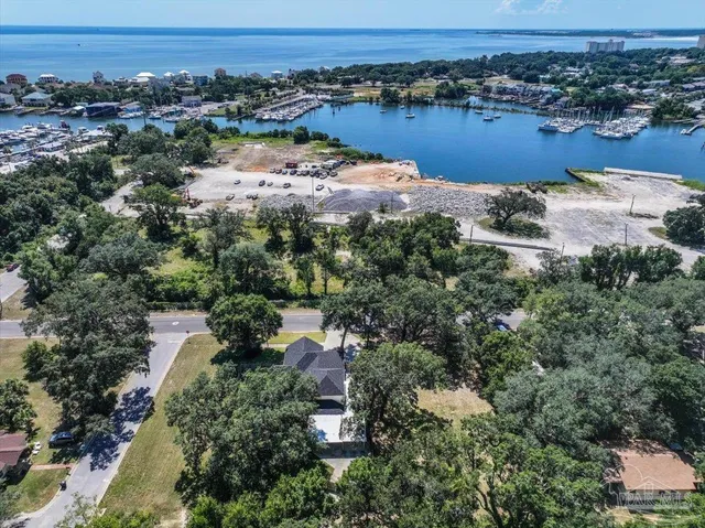 an aerial view of residential houses with outdoor space and lake view