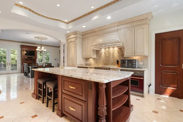 a kitchen with stainless steel appliances granite countertop a stove and a refrigerator