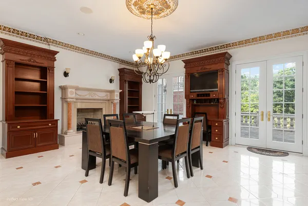a view of a dining room with furniture and a chandelier
