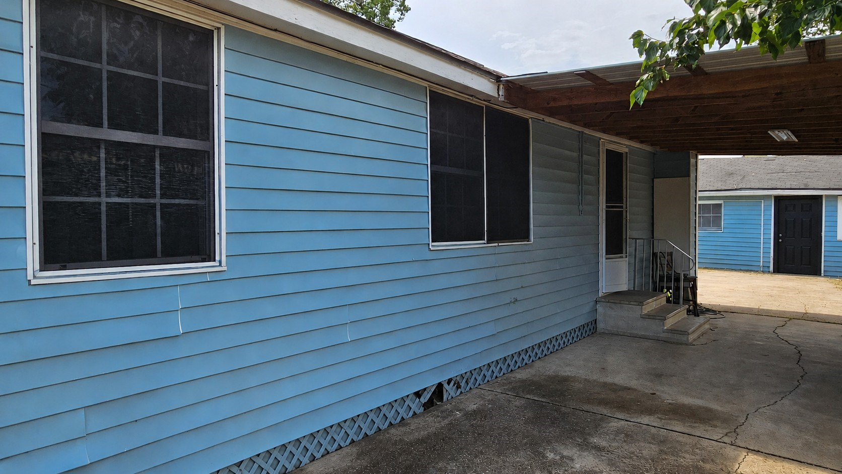 2415 Perry Street Baytown, TX 77521 - Photo 17 of 23 Covered parking connects to kitchen for rain-free grocery hauls!