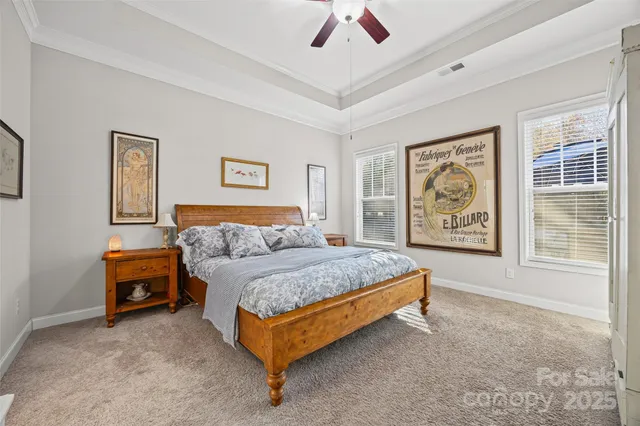 a spacious bedroom with a bed and a painting on the wall