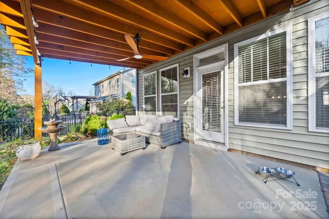 a view of a patio with table and chairs and potted plants