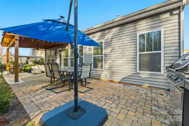 a view of a patio with a table chairs and backyard