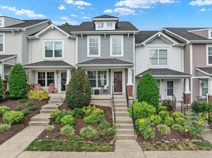 front view of a brick house with a yard