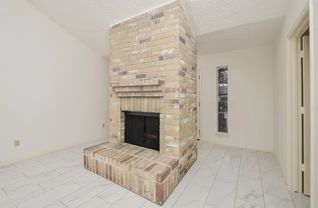 a view of an empty room with fire place