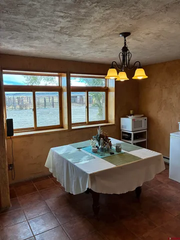 a dining room with a table and chairs