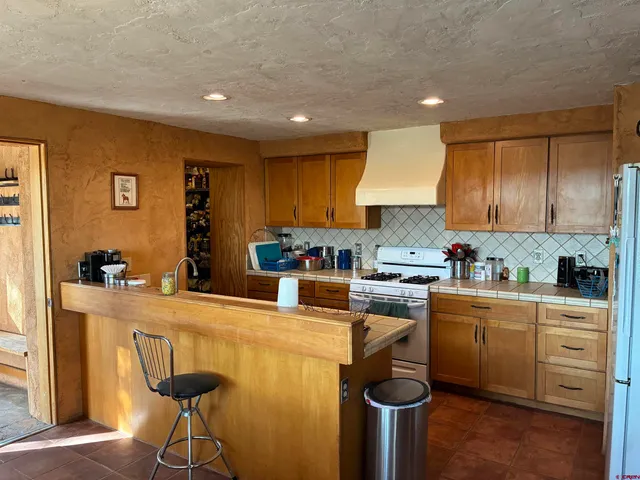 a kitchen with granite countertop a sink stainless steel appliances and cabinets