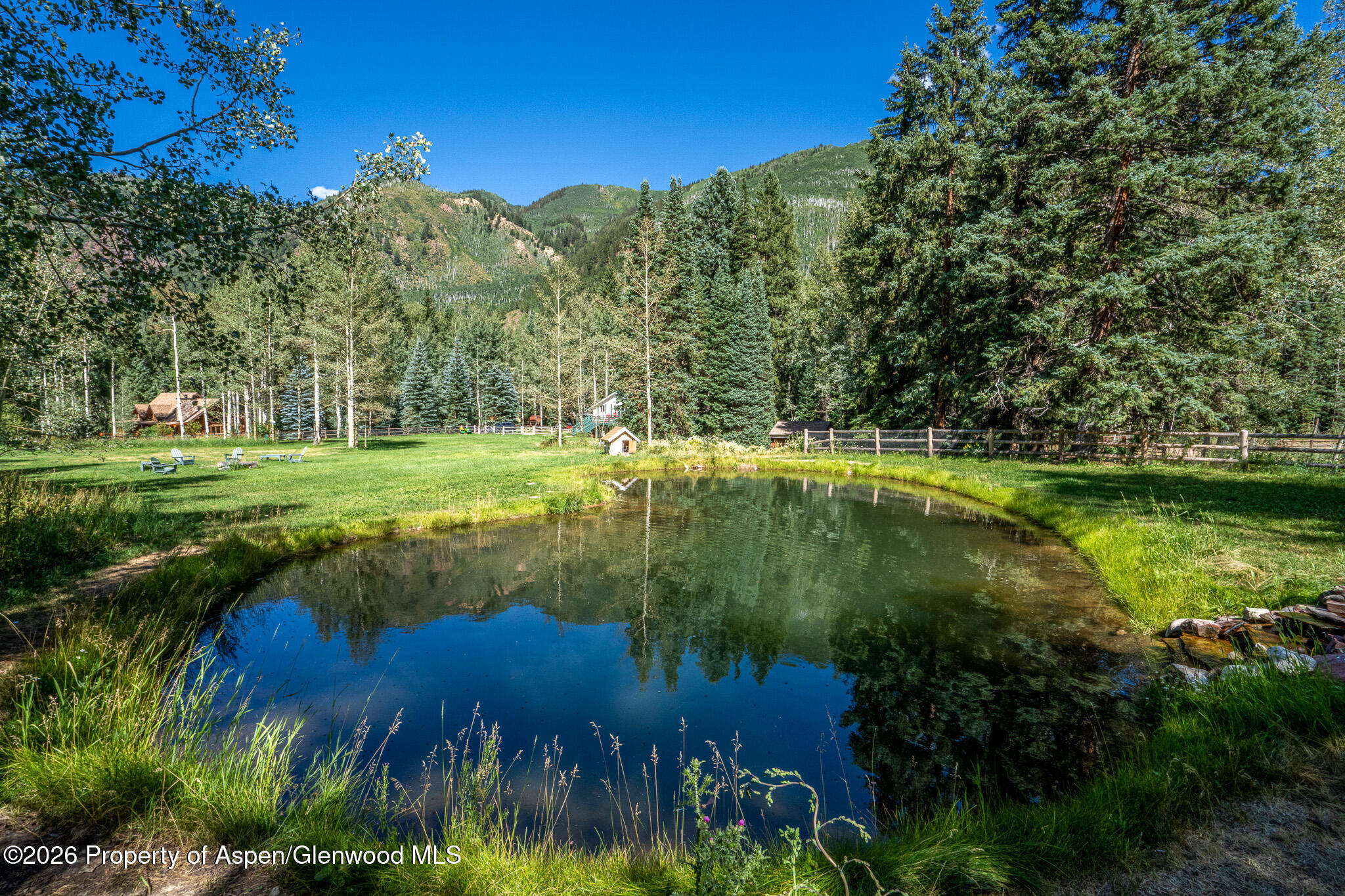285 Conundrum Creek Road Aspen, CO 81611 - Photo 28 of 35 a view of a lake with a yard