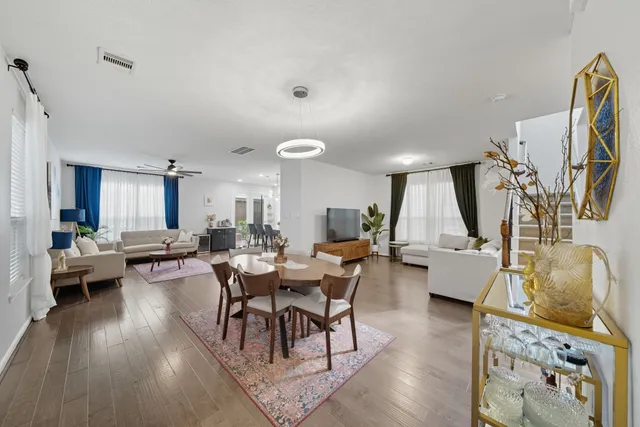 a living room with fireplace furniture and a wooden floor