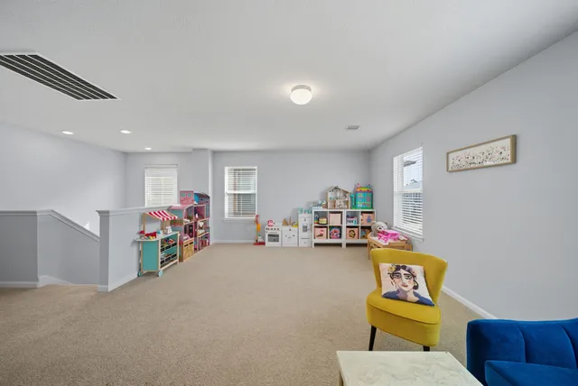 a view of a livingroom with furniture and toys