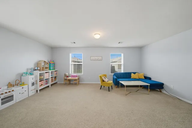 a view of a livingroom with furniture and toys