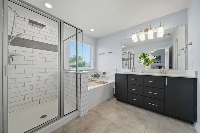 a spacious bathroom with a tub shower and sink