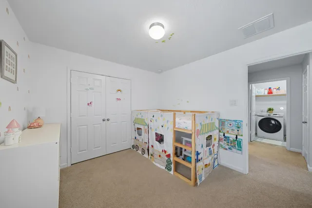 a bedroom with furniture and white walls