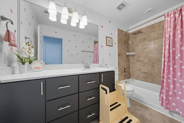 a bathroom with a sink double vanity mirror and a bathtub