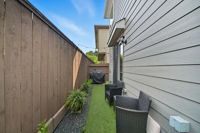a house view with couches in backyard