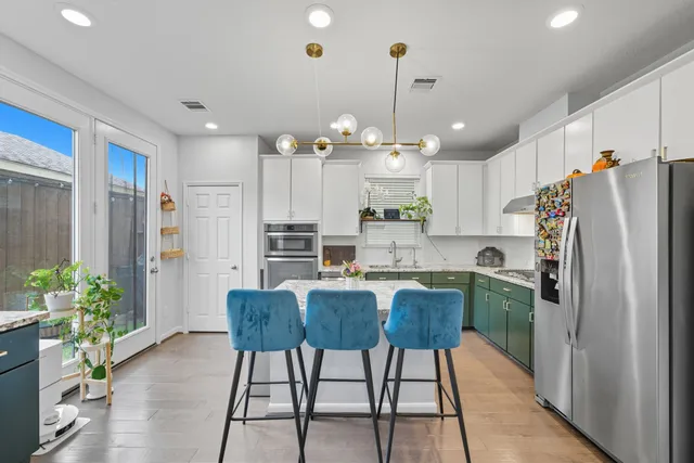 a kitchen with refrigerator and cabinets