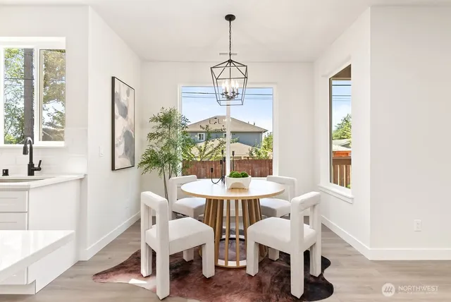 a view of staircase with lots of frames on wall and a chandelier