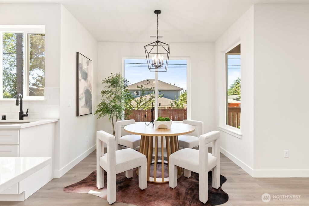 1720 South Tyler Street Tacoma, WA 98405 - Photo 11 of 14 a dining room with furniture a chandelier and wooden floor
