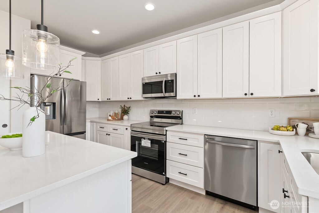1720 South Tyler Street Tacoma, WA 98405 - Photo 9 of 14 a kitchen with a sink a stove and refrigerator