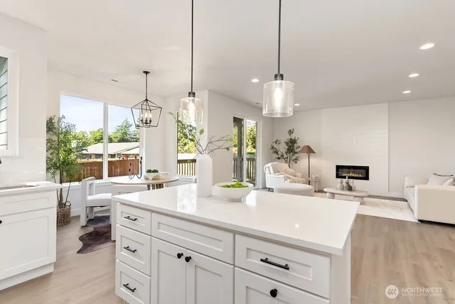 a dining room with furniture a chandelier and wooden floor