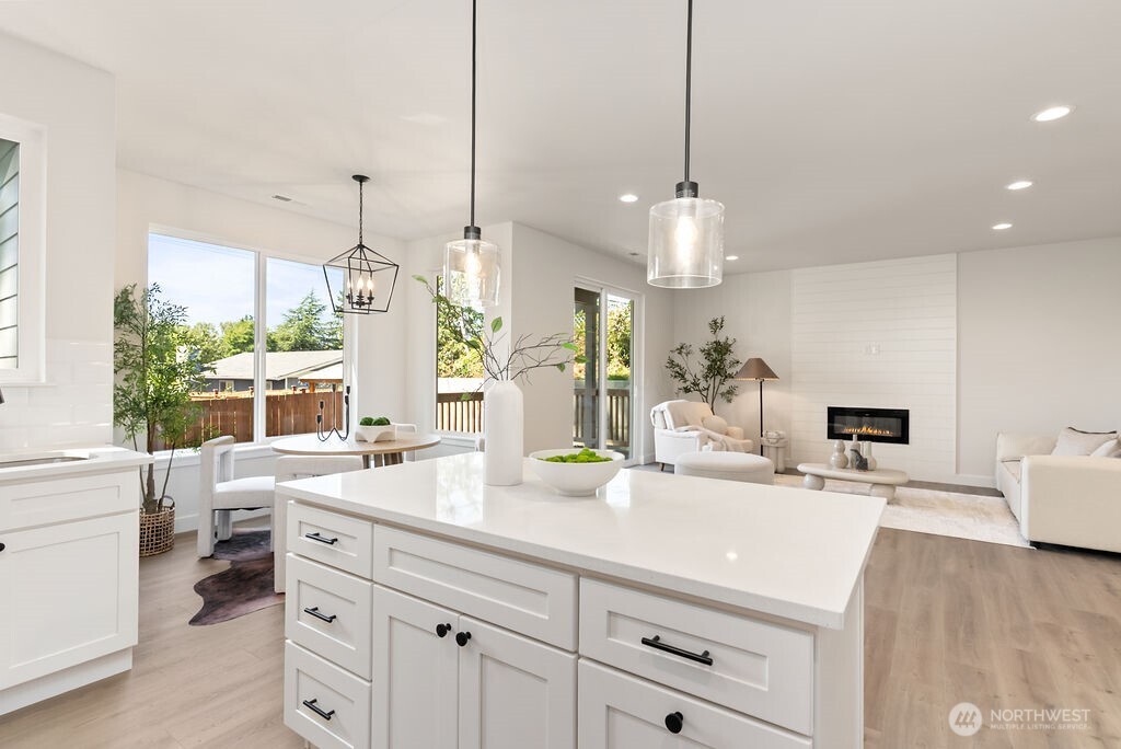 1720 South Tyler Street Tacoma, WA 98405 - Photo 10 of 14 a room with kitchen island a chandelier and a sink