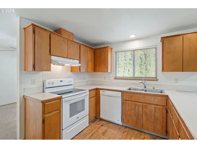 a kitchen with stainless steel appliances granite countertop a sink stove and cabinets