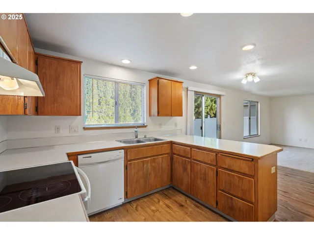 a kitchen with a sink a window and cabinets