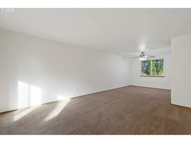 a view of an empty room and a window