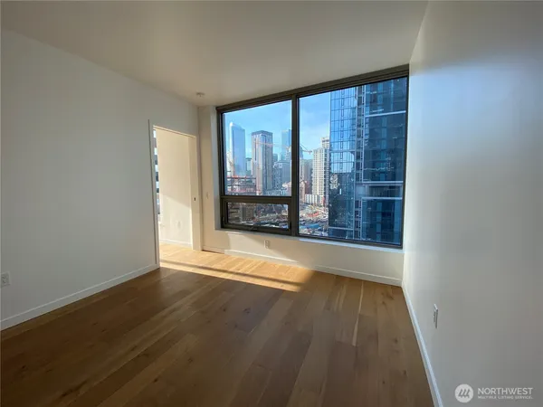wooden floor in an empty room with a window