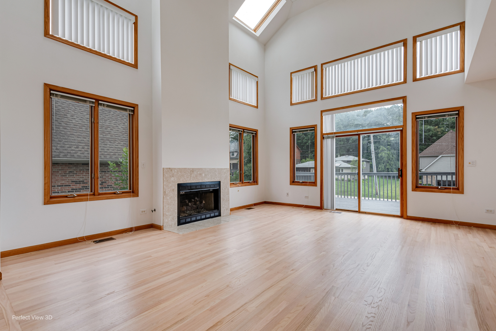 16W234 91st Street Burr Ridge, IL 60527 - Photo 5 of 31 an empty room with wooden floor fireplace and windows