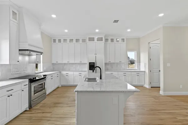 a kitchen with a sink stove and cabinets