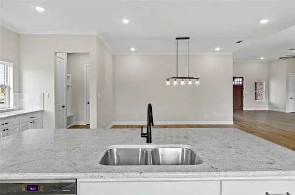 a bathroom with a sink double vanity granite tub shower and a mirror