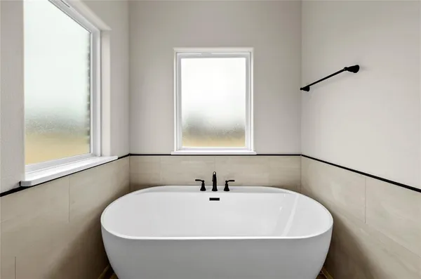 a bathroom with a shower and a glass door