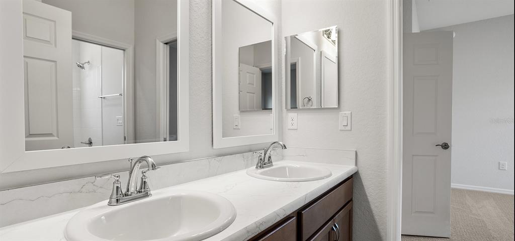 7550 Southwest 107th Lane Ocala, FL 34476 - Photo 14 of 22 a bathroom with double sink and a mirror