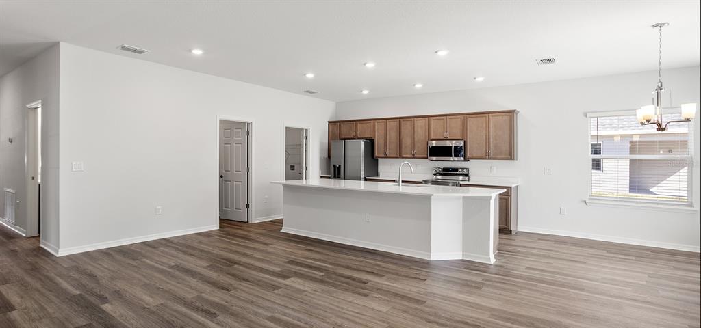 7550 Southwest 107th Lane Ocala, FL 34476 - Photo 4 of 22 a kitchen with stainless steel appliances granite countertop a refrigerator sink and white cabinets