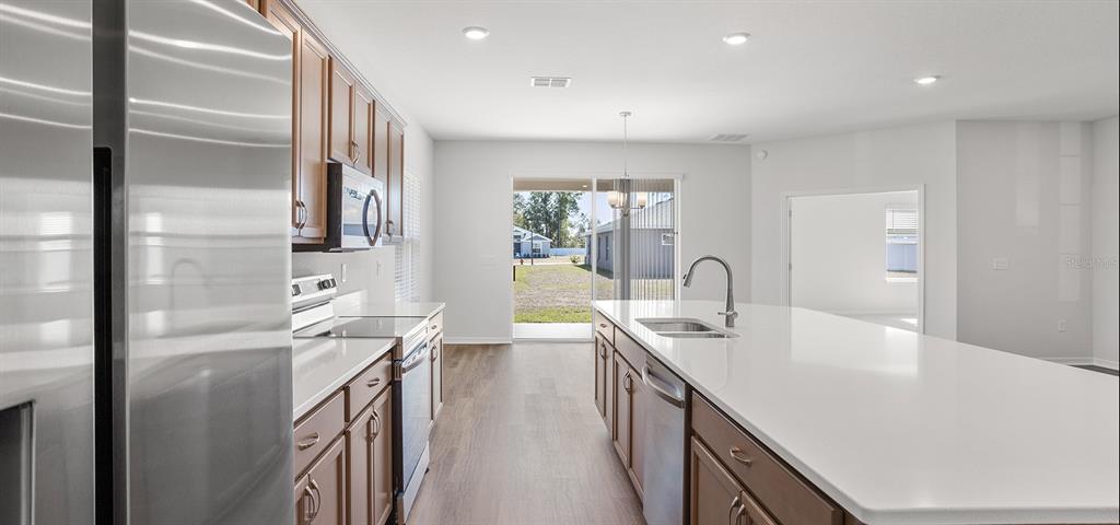 7550 Southwest 107th Lane Ocala, FL 34476 - Photo 6 of 22 a kitchen with kitchen island a sink appliances and a counter top space