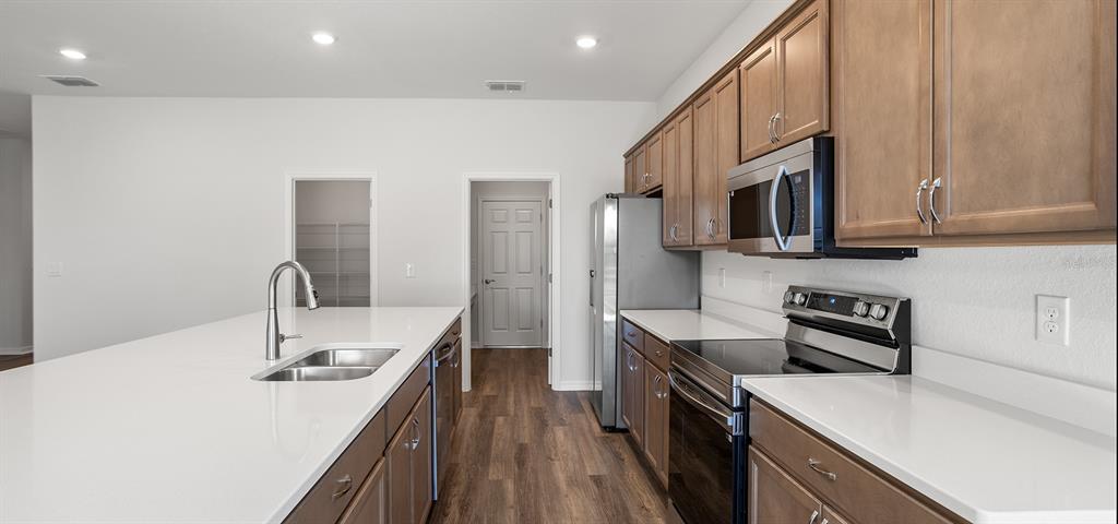 7550 Southwest 107th Lane Ocala, FL 34476 - Photo 8 of 22 a kitchen with stainless steel appliances a sink stove and refrigerator