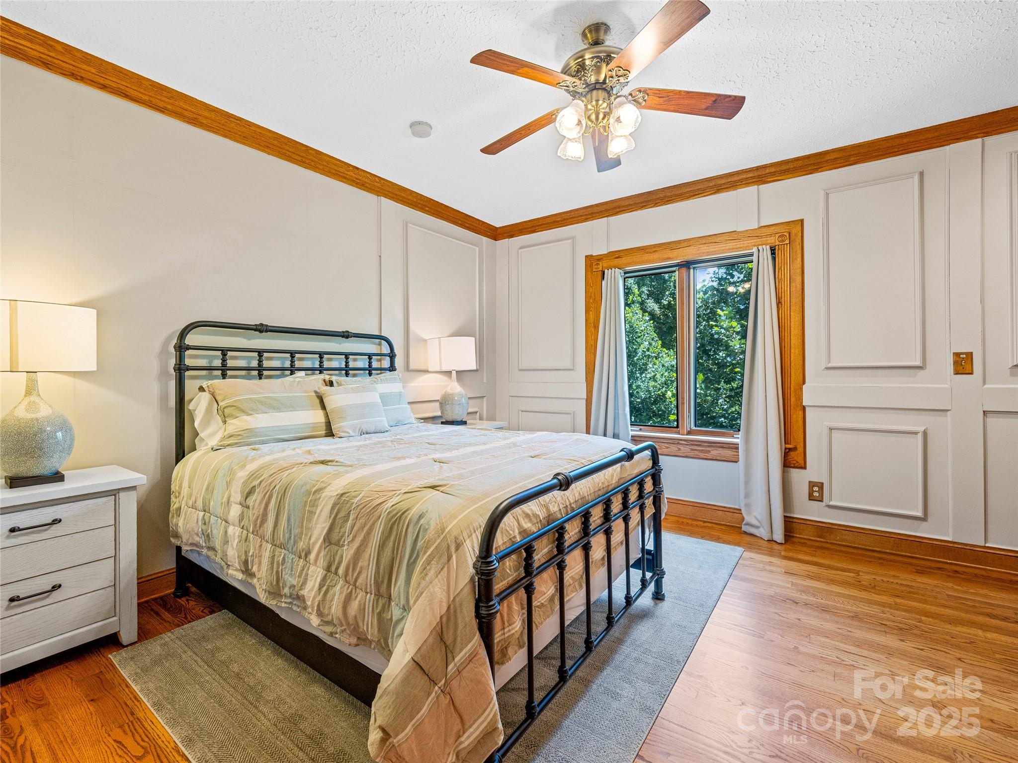 514 Lab Mountain Trail Clyde, NC 28721 - Photo 25 of 37 a bedroom with a large bed and a chandelier