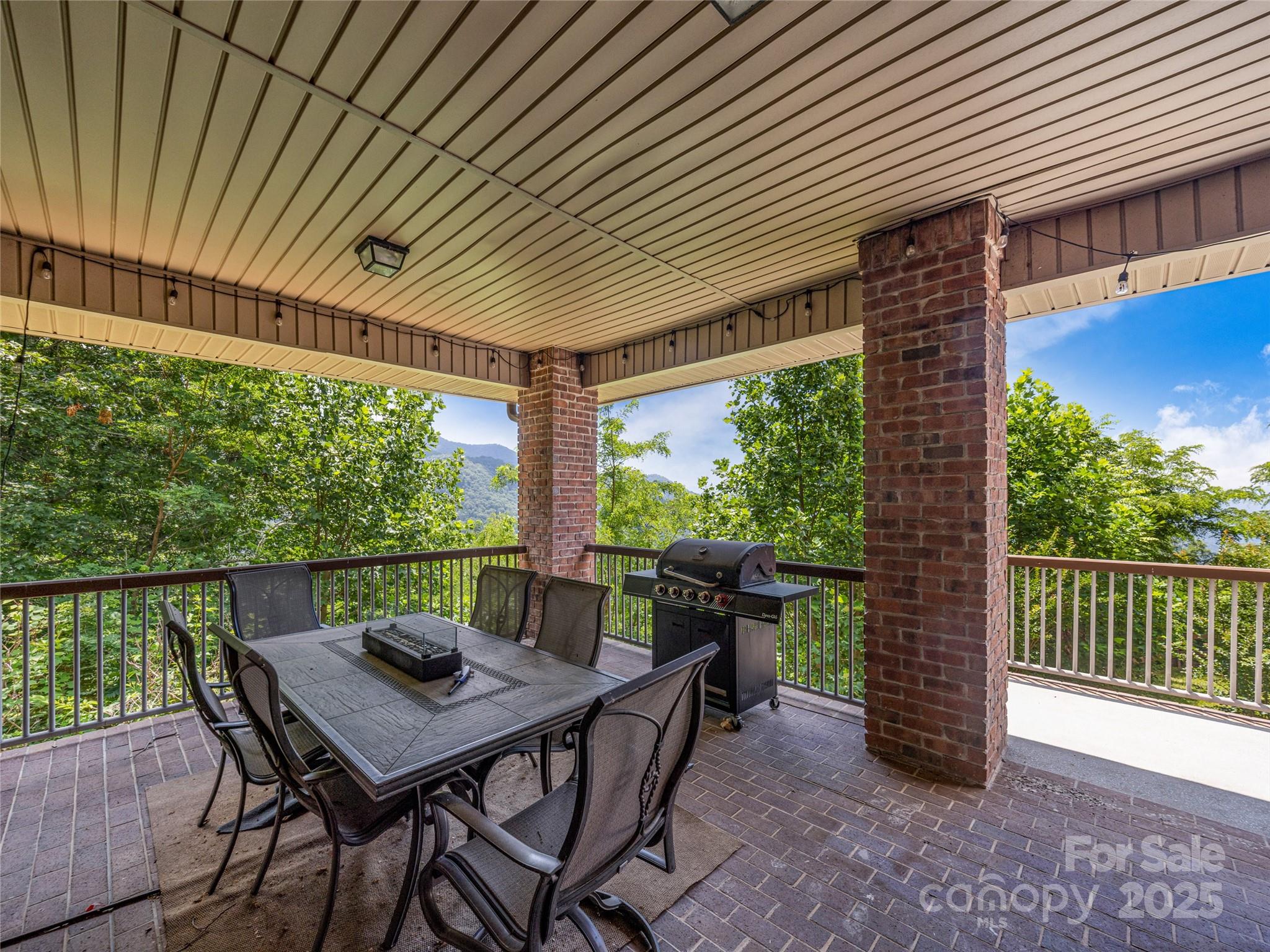 514 Lab Mountain Trail Clyde, NC 28721 - Photo 32 of 37 a view of a patio with a table chairs and a table