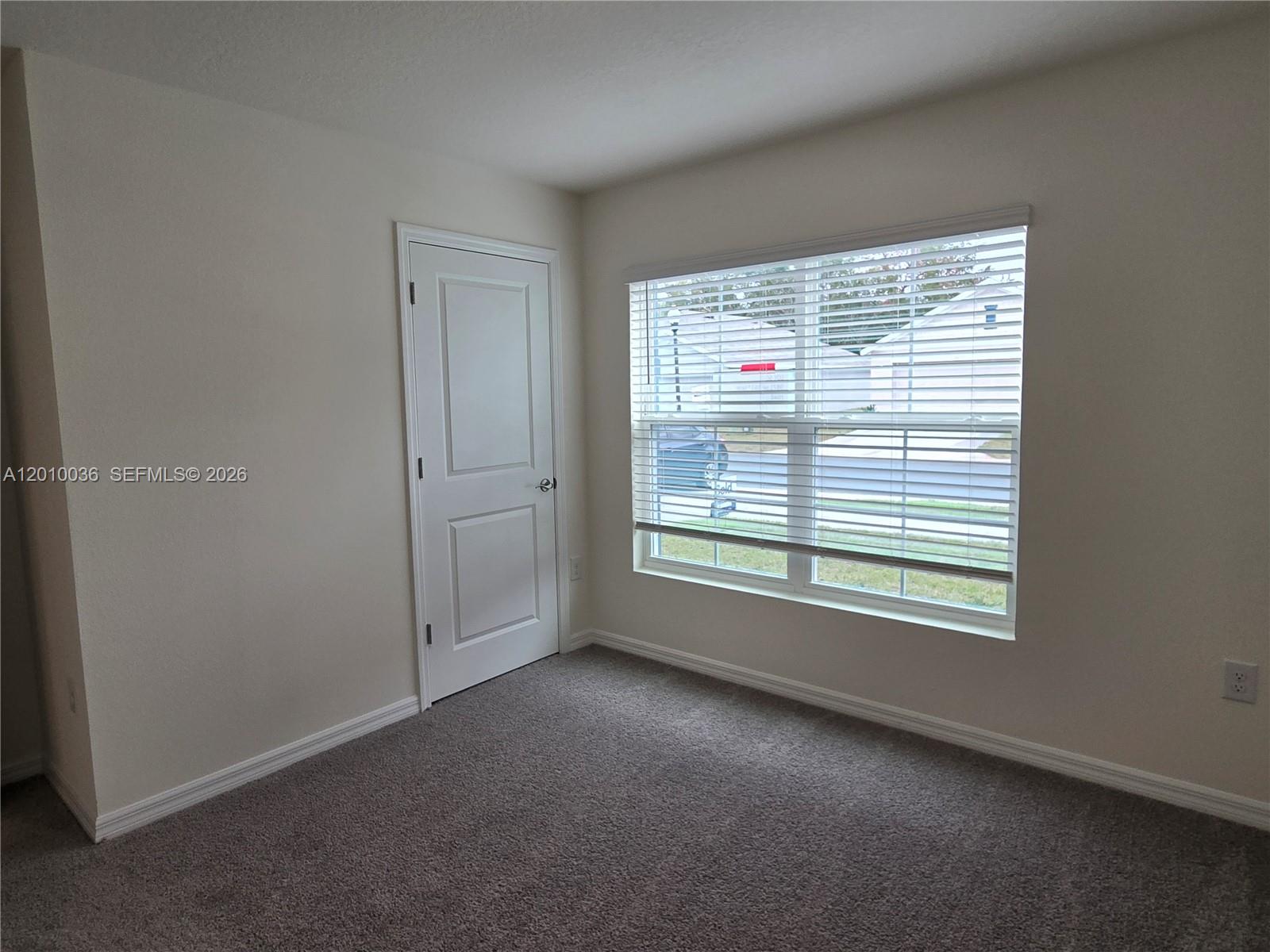 9871 Southeast 161st Lane Road Summerfield, FL 34491 - Photo 12 of 31 an empty room with windows