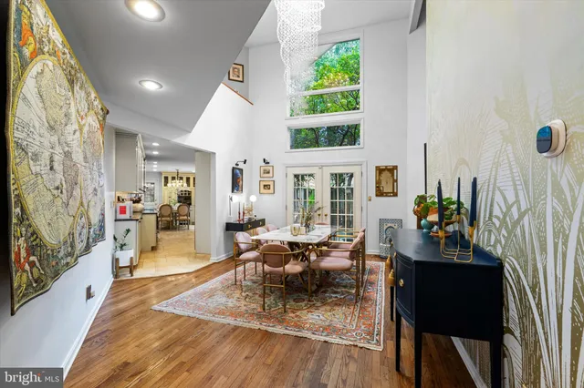 a very nice looking dining room with a large window and chandelier