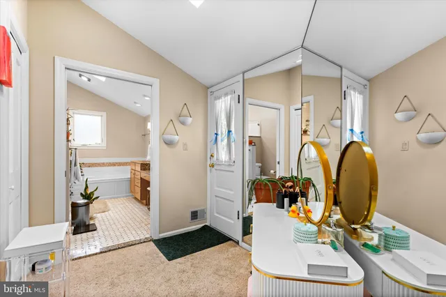 a large bed sitting in a living room next to a window